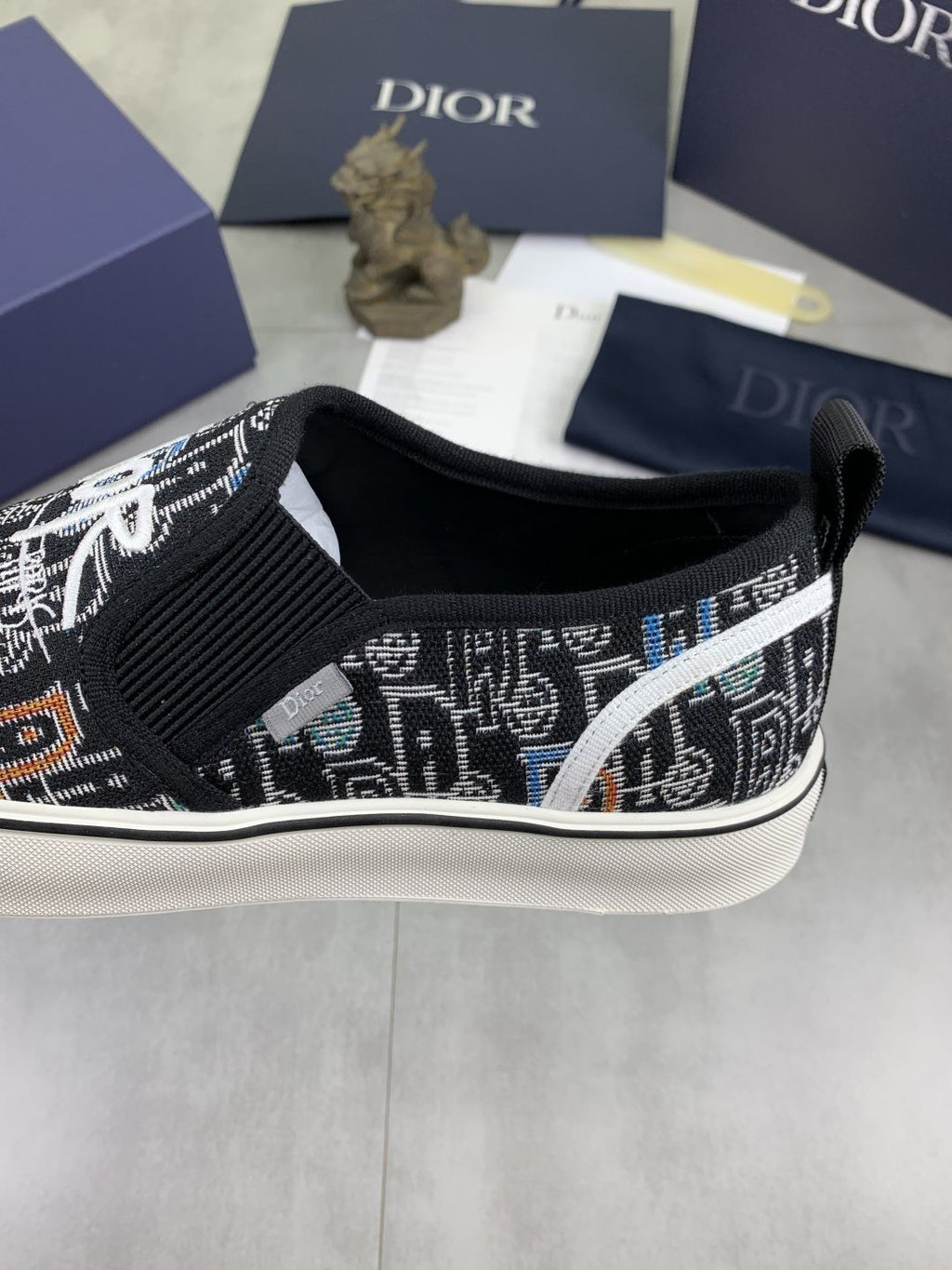Dior Graphic Canvas Slip-On Sneakers - Black, White and Tan